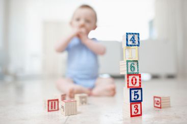 Baby child, toys and building blocks in home, curious...
