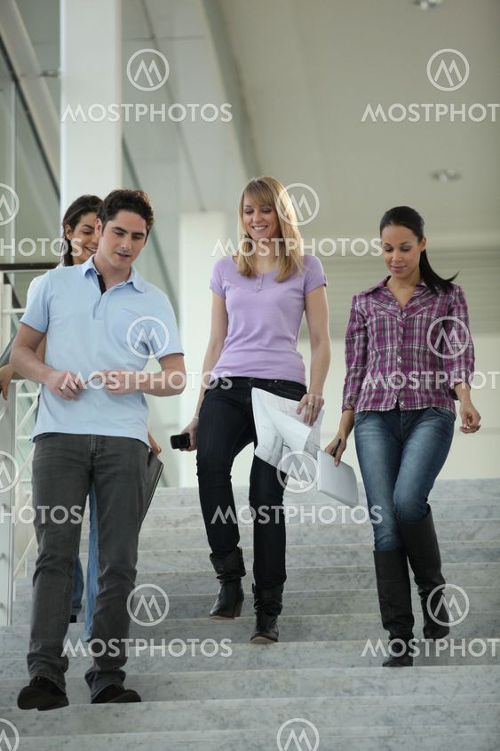 Happy students coming down stairs