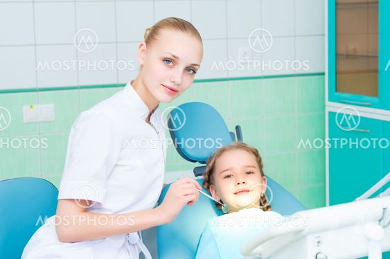 young doctor woman and girl in dentist office