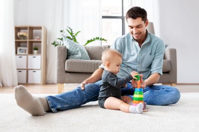 father playing with little baby daughter at home