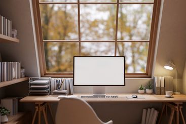 A cozy, minimal woody home office workspace features a...