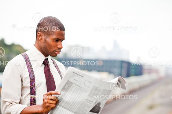 Businessman reading newspaper