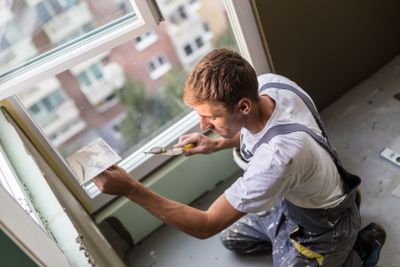 Plasterer renovating indoor walls and ceilings.
