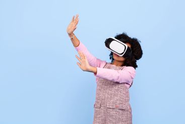 Girl exploring virtual reality with excitement and joy