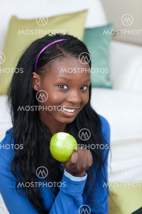 Jolly woman eating an apple