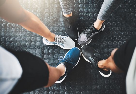 Life is better in gym shoes. a group of people standing...