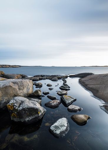 Coastal rocks and calm waters outside Gothenburg create...