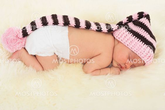 infant sleeping in the white sheep's clothing.