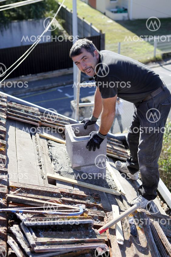 Roofer replacing shingles