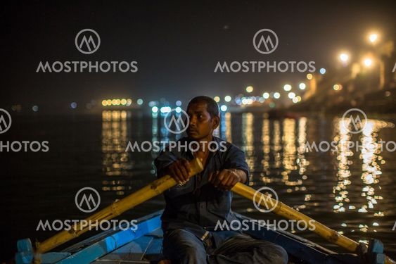 Boatmen on the Ganga river at night. Varanasi is one of the most important pilgrimage sites in India and is one of the 7 sacred cities of Hinduism.
