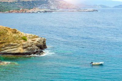 Empty motorboat drifting on waves in Bali, Crete