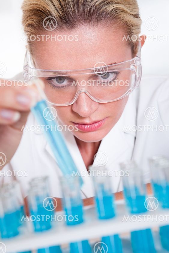 Lab technician woman looking at testubes
