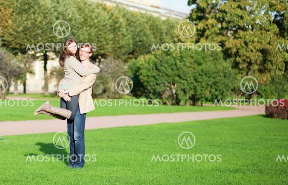 Happy couple enjoying sunny autumn day in park