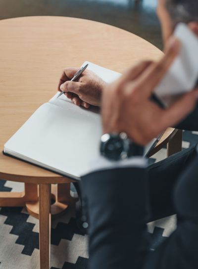 businessman writing in notebook