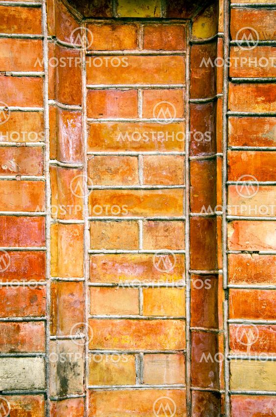 Old ancient gate made of red brick background.