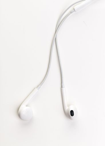 Pair of earphones close up on grey background