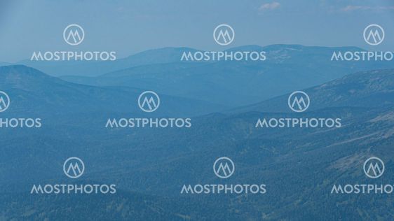 View of calming mountain valley with ridge on horizon....