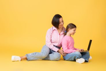 Mother and daughter bonding while using a laptop...