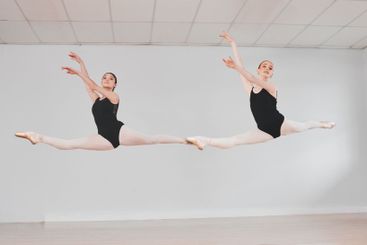 Girl, friends and ballet dancer with jump for...