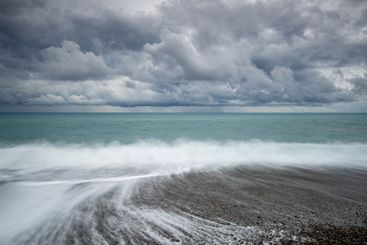 Windy waves crashing on a coast on a stormy day in winter.