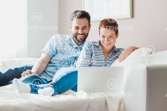 Young couple watching laptop