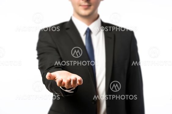 Businessman holds out his hand