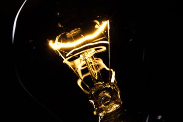 Close-up of electrical bulb on black background