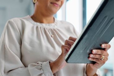 Business woman, tablet and hands for typing in modern...
