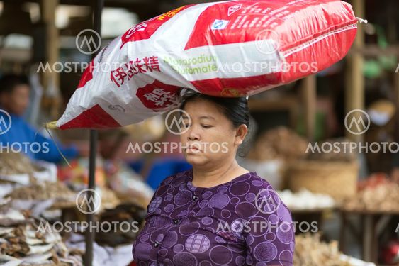 Woman carrying monosodium glutamate bag