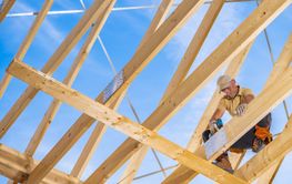 Construction Worker Assembling Wooden Framework Under...