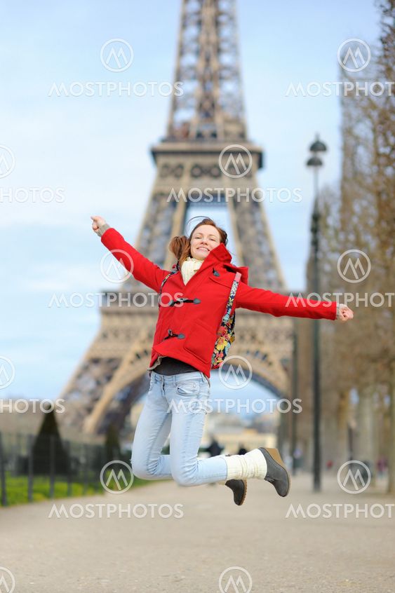 Young woman near the Eiffel tower, in Paris, France