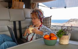 One independent woman laying and working inside a camper...
