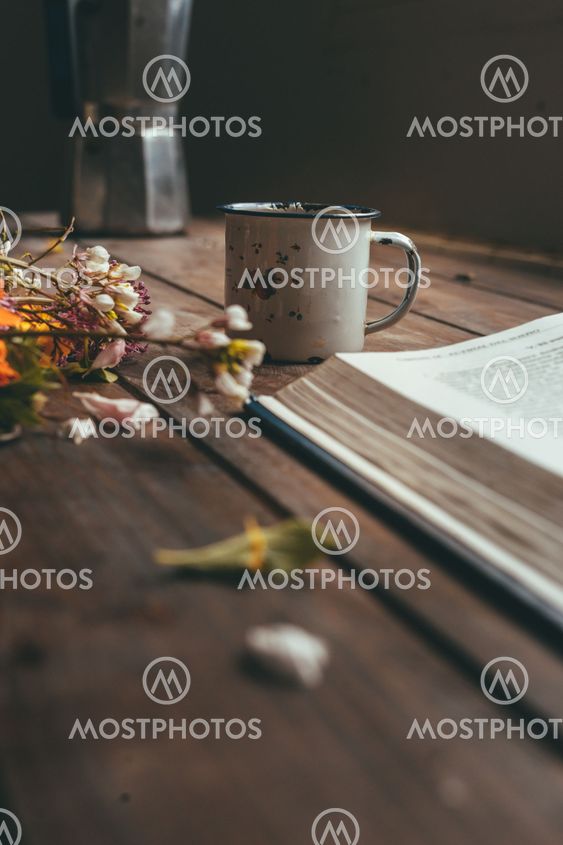 Flowers, coffee and book on the table