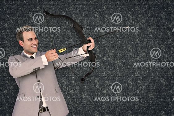 Composite image of businessman shooting arrow