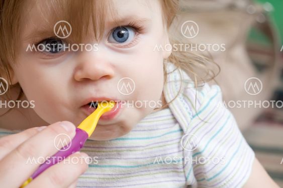 toddler getting her new teeth cleaned