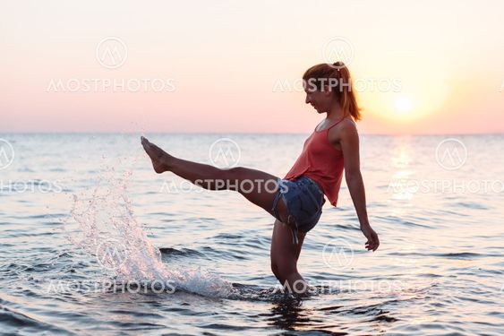 Young woman enjoying sea and sunset