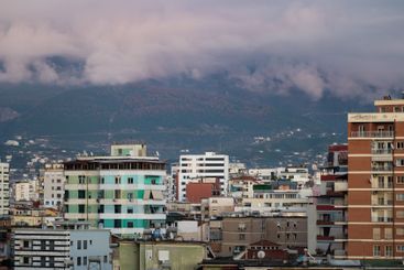 blocks and mountains at dusk in the city of Tirana, Albania