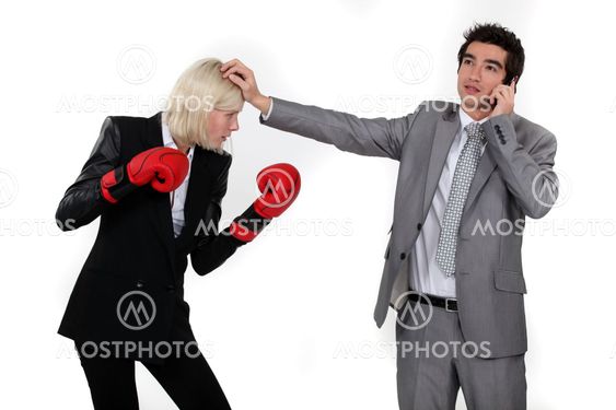 Man taking a break from fighting with his colleague to answer the phone