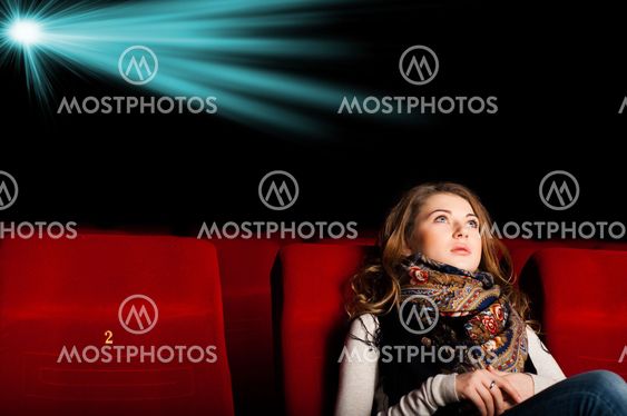 young attractive woman sitting in a cinema
