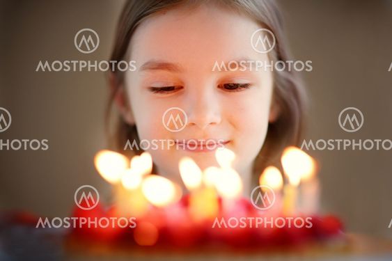 Adorable little girl and a raspberry cake