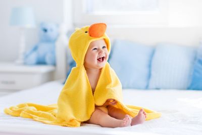 Cute baby after bath in yellow duck towel