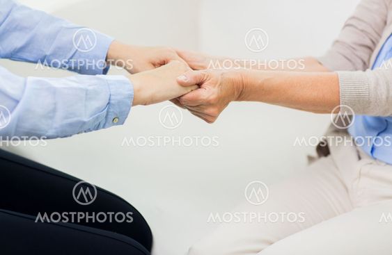 close up of senior and young woman hands