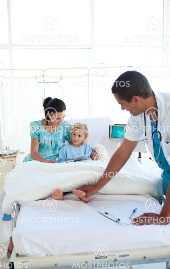 Doctor examining a little girl with her mother in tow