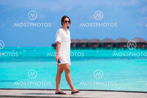 Young woman listening music on summer vacation