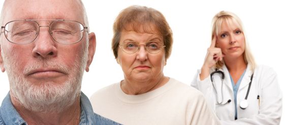 Concerned Senior Couple and Female Doctor Behind