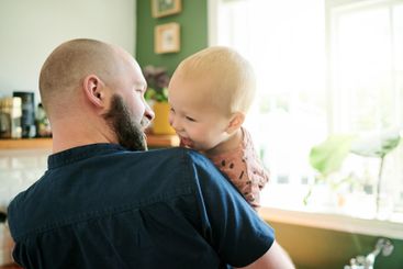 Father, kid and single parent playing with a child in a...