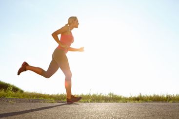 Woman, profile and running with blue sky on mountain for...