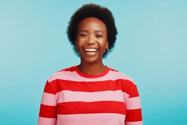 Happy, laughing and portrait of black woman in studio...