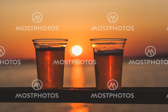 Two beer cups with setting sun