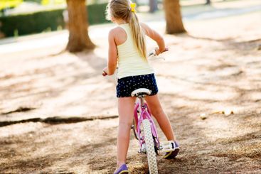 Back, child and outdoor for riding bicycle, learning...